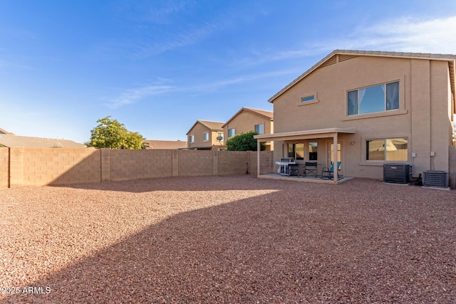 back of property featuring a patio area, stucco siding, central AC, and a fenced backyard