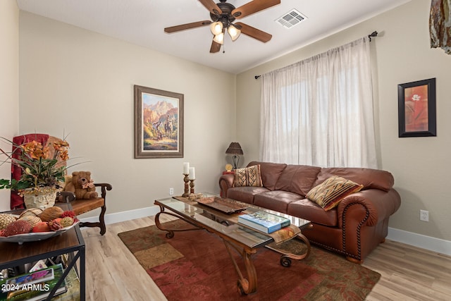 living room with light wood-type flooring and ceiling fan