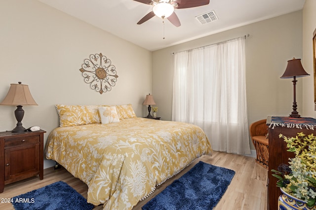 bedroom with light hardwood / wood-style flooring and ceiling fan