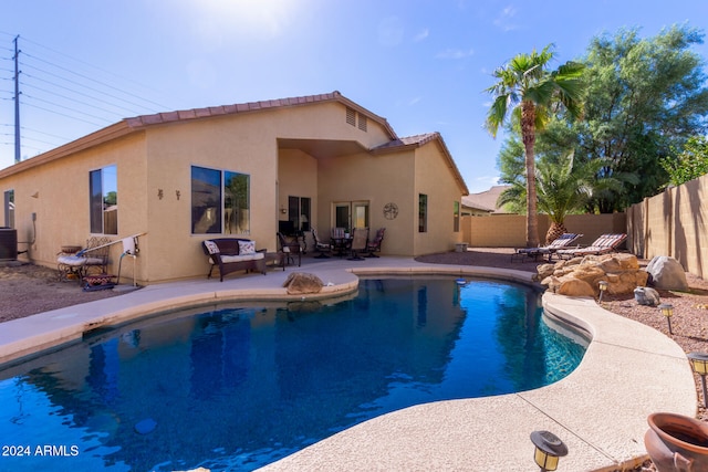 view of swimming pool featuring a patio area and cooling unit