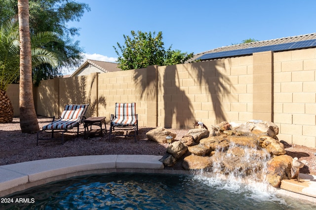 view of swimming pool featuring pool water feature