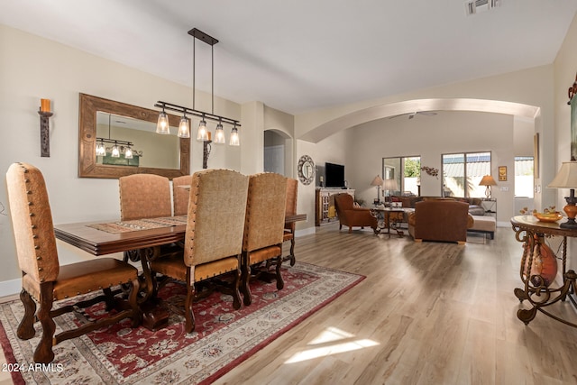 dining space with lofted ceiling and hardwood / wood-style flooring