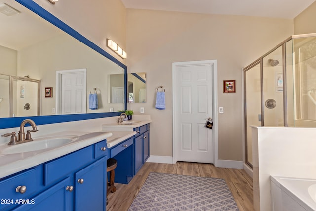 bathroom with vanity, hardwood / wood-style flooring, and independent shower and bath