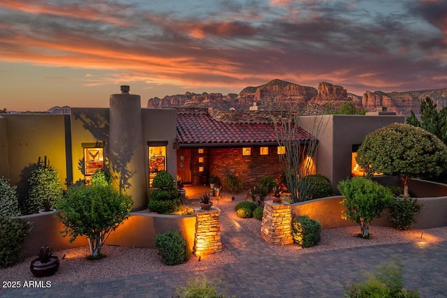 30 Paraiso Corte, Sedona, AZ 86351 - view of front of property with a chimney, stucco siding, and a tiled roof