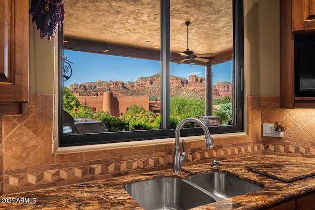 30 Paraiso Corte, Sedona, AZ 86351 - kitchen view of a sink, a ceiling fan, tasteful backsplash, dark stone countertops, and a mountainous background