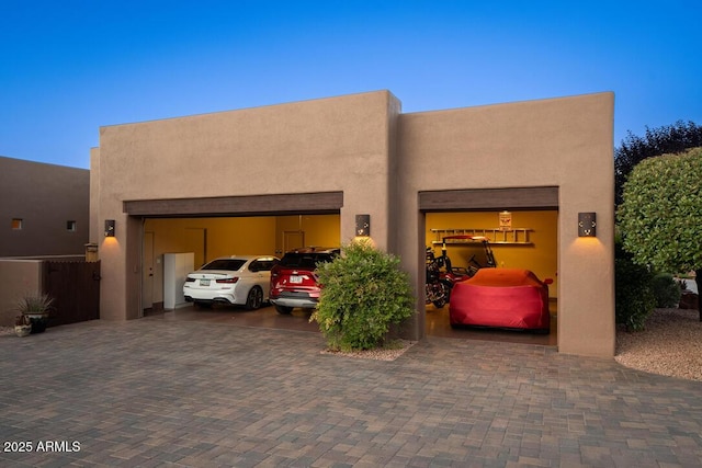 30 Paraiso Corte, Sedona, AZ 86351 - pueblo-style house featuring an attached garage, driveway, and stucco siding