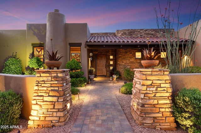 30 Paraiso Corte, Sedona, AZ 86351 - view of front of house featuring a chimney, stucco siding, and a tile roof