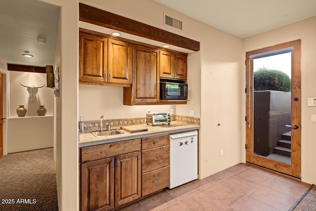 30 Paraiso Corte, Sedona, AZ 86351 - kitchen with a sink, dishwasher, black microwave, brown cabinets, and tile counters
