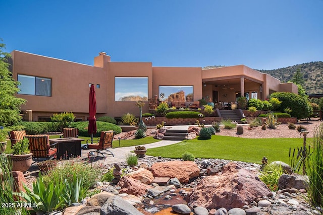 30 Paraiso Corte, Sedona, AZ 86351 - rear view of house with a fire pit, a yard, a ceiling fan, and stucco siding