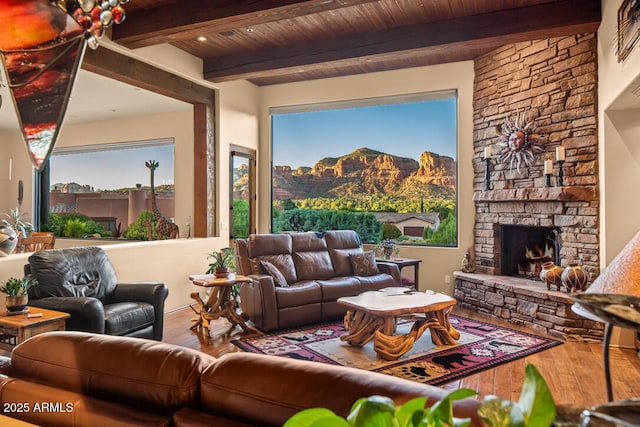 30 Paraiso Corte, Sedona, AZ 86351 - living room with wood finished floors, a fireplace, a mountain view, and wooden ceiling with exposed beams
