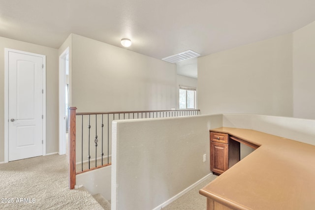 hall with light colored carpet