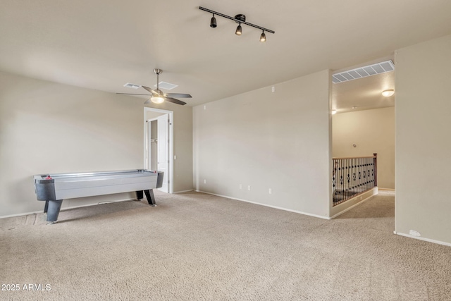 game room featuring track lighting, ceiling fan, and light carpet