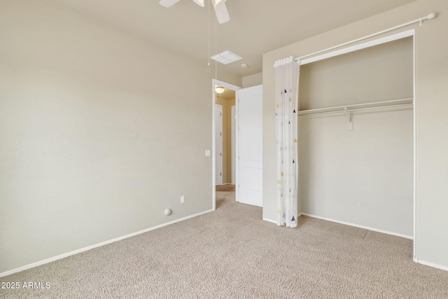 unfurnished bedroom with ceiling fan, a closet, and light carpet