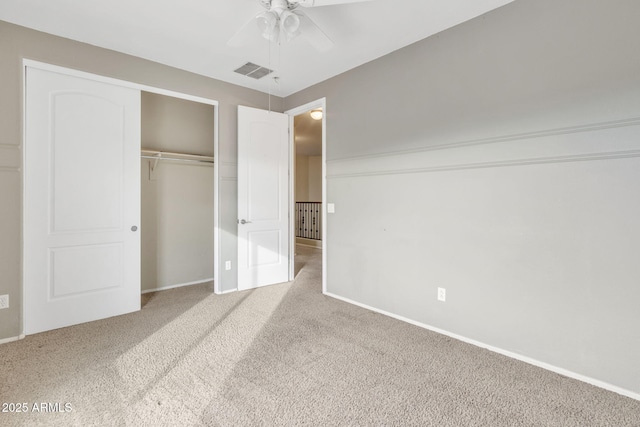 unfurnished bedroom featuring ceiling fan, light colored carpet, and a closet