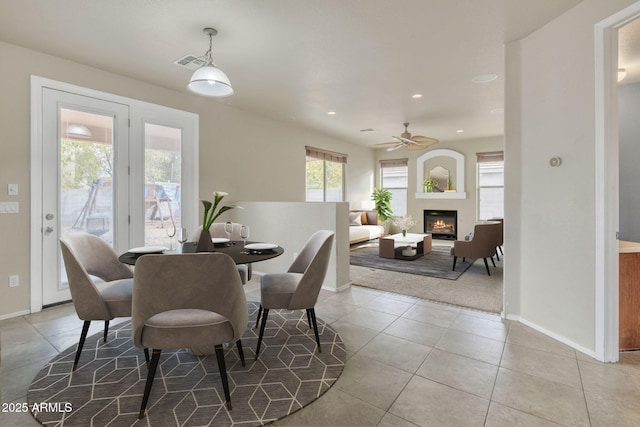 tiled dining room featuring ceiling fan