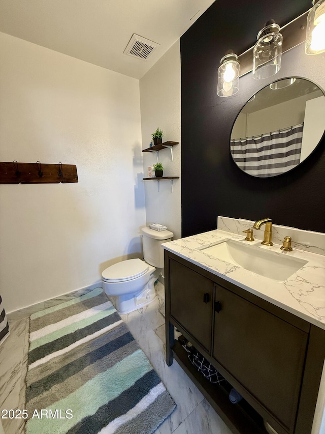 bathroom with vanity and toilet