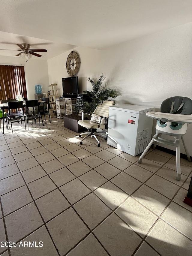 tiled living room featuring ceiling fan