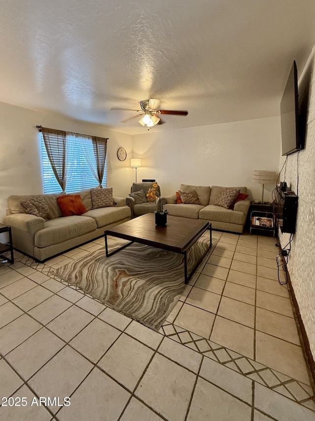 tiled living room featuring ceiling fan and a textured ceiling