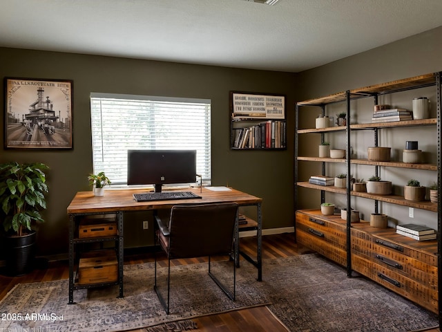 office space featuring baseboards and wood finished floors