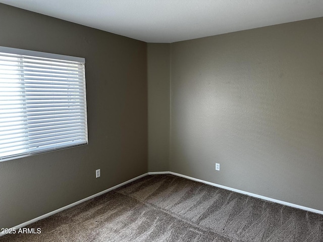 carpeted spare room with baseboards