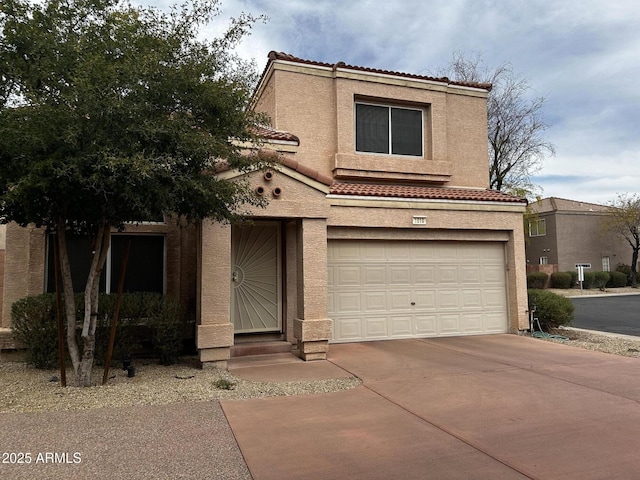 mediterranean / spanish-style house featuring a garage, concrete driveway, stucco siding, and a tiled roof