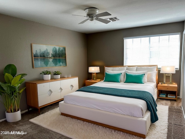 carpeted bedroom featuring visible vents and a ceiling fan