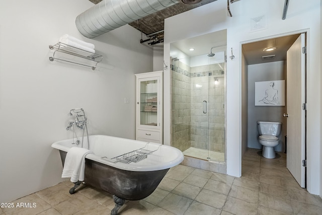 bathroom featuring toilet, visible vents, a shower stall, tile patterned flooring, and a soaking tub