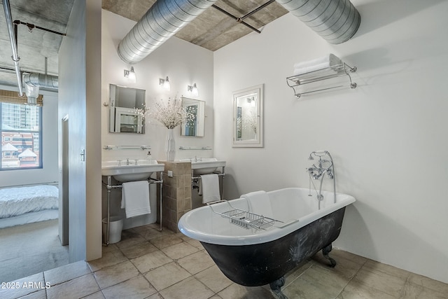 bathroom featuring tile patterned flooring and a soaking tub