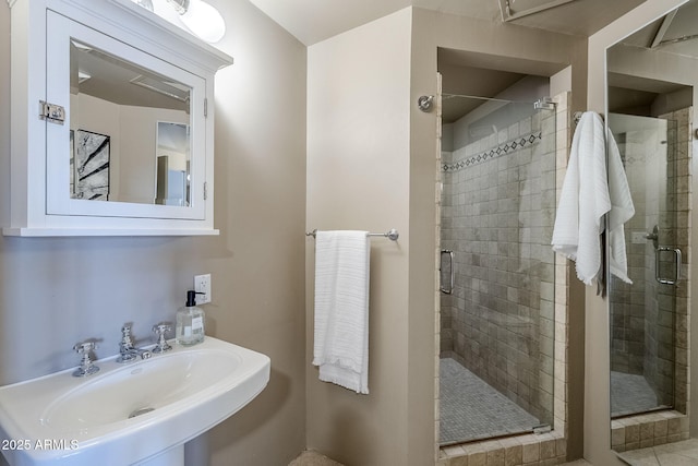 bathroom featuring a sink and a stall shower