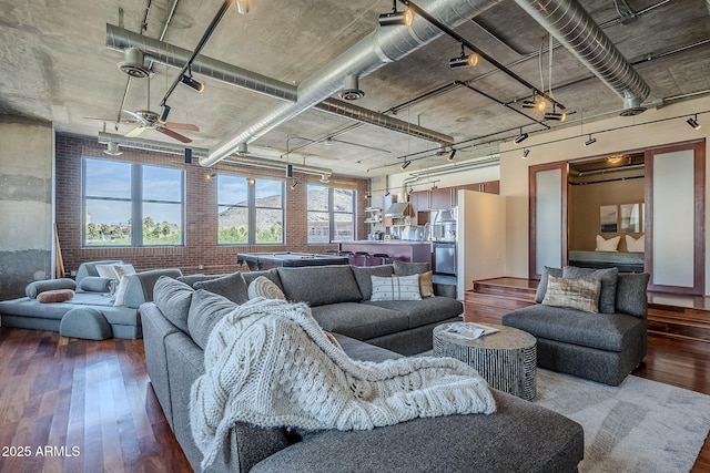 living room featuring track lighting, hardwood / wood-style floors, and a ceiling fan