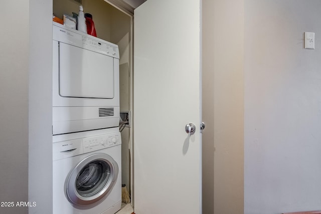 laundry area with laundry area and stacked washer and dryer