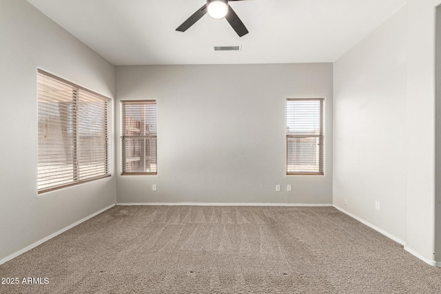 carpeted empty room featuring ceiling fan