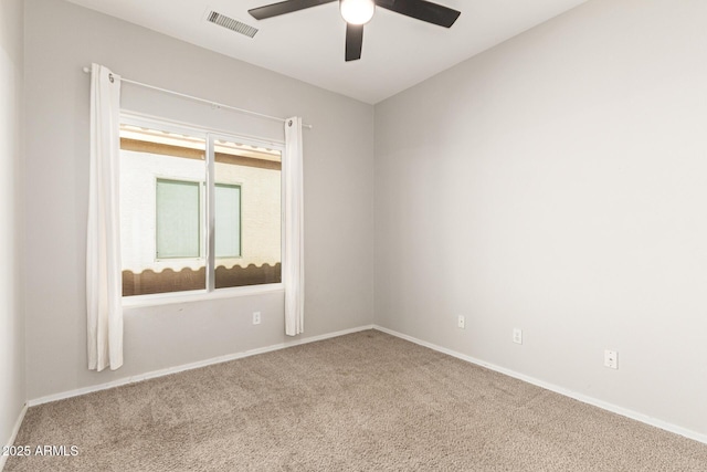 carpeted spare room with ceiling fan and a wealth of natural light