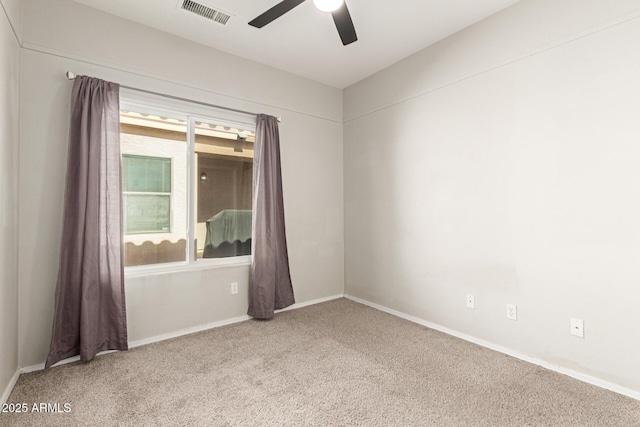 carpeted empty room featuring ceiling fan