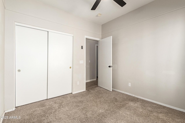 unfurnished bedroom with ceiling fan, carpet, and a closet