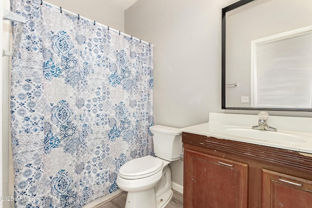 bathroom with toilet, vanity, and a shower with curtain