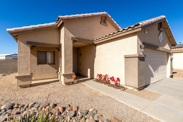 back of property featuring a garage