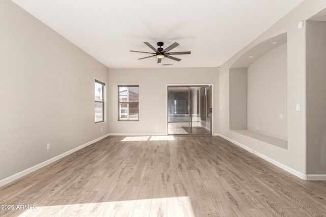 empty room with ceiling fan and hardwood / wood-style floors