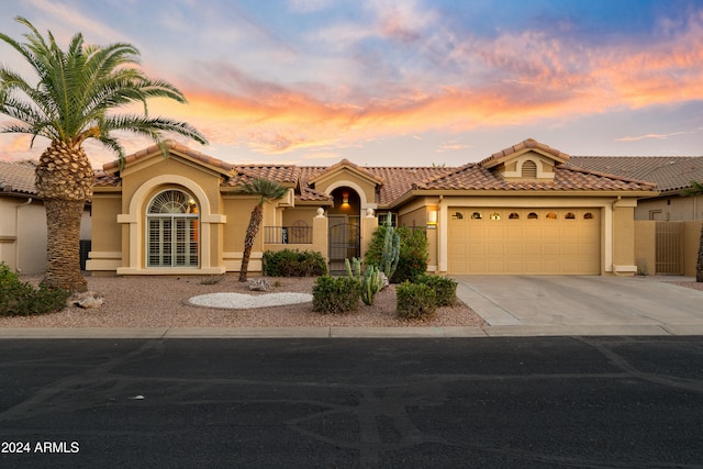 mediterranean / spanish house with a garage