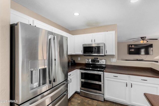 kitchen with stainless steel appliances, white cabinetry, and ceiling fan