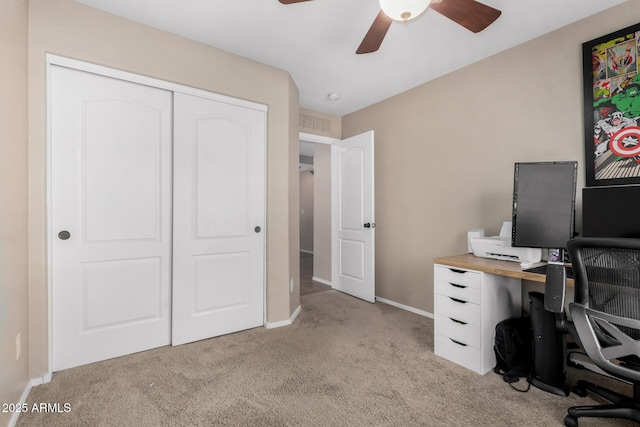 carpeted home office with ceiling fan