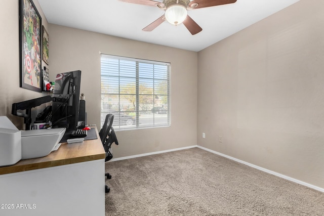 carpeted home office featuring ceiling fan