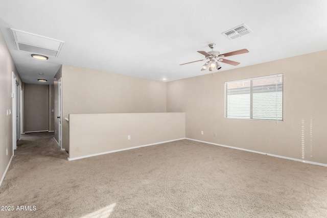 carpeted spare room with ceiling fan