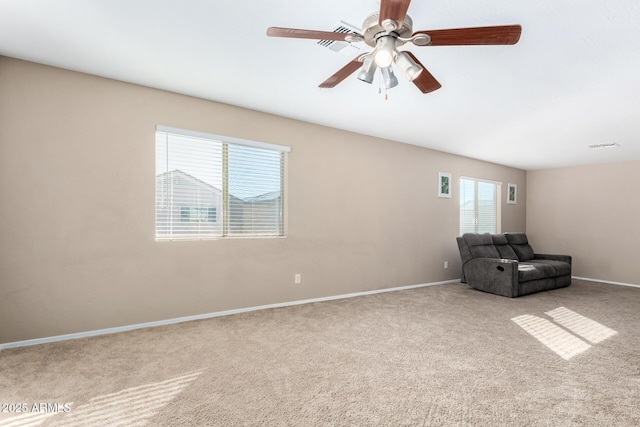 unfurnished room with ceiling fan and carpet