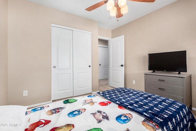 carpeted bedroom featuring a closet and ceiling fan