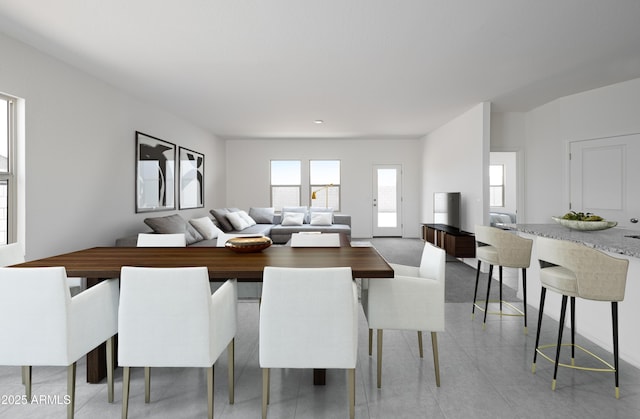 dining space featuring light tile patterned flooring and baseboards