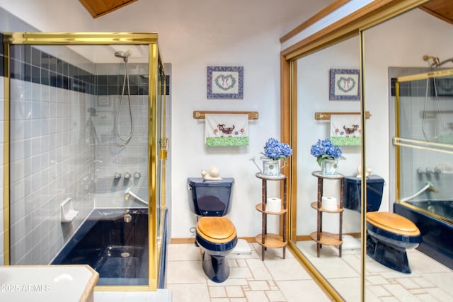 bathroom featuring an enclosed shower, toilet, tile patterned floors, and baseboards