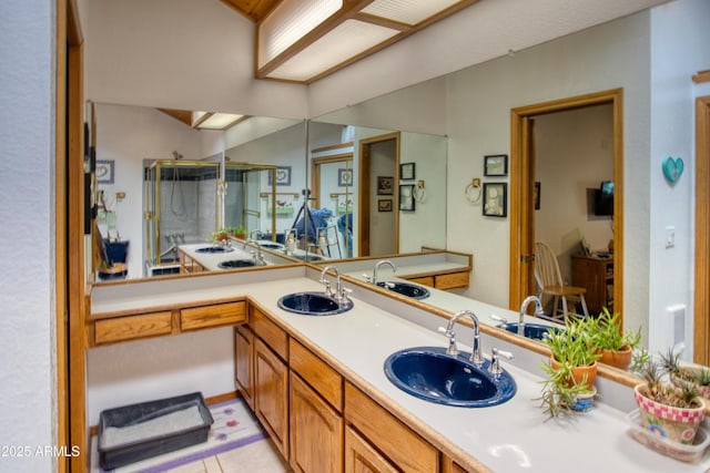 full bath featuring a shower stall and double vanity