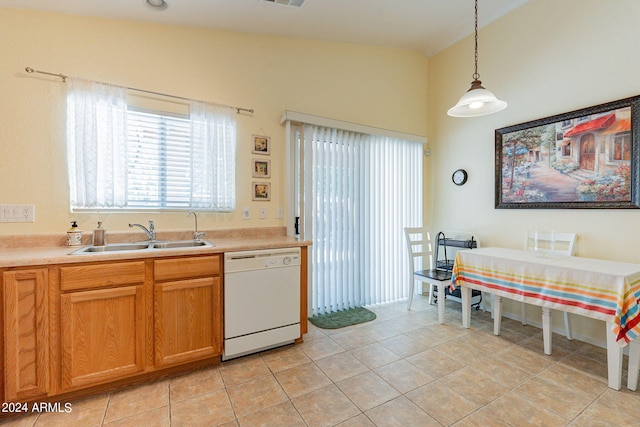 kitchen with sink, dishwasher, vaulted ceiling, and light tile patterned flooring