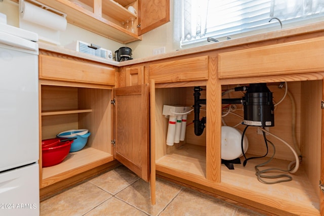 details with light tile patterned floors and white fridge